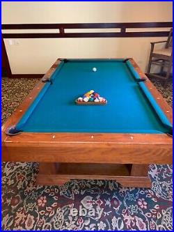 9ft. Brunswick pool table. New green felt. Includes cue rack and accessories