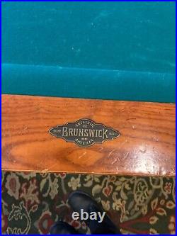 9ft. Brunswick pool table. New green felt. Includes cue rack and accessories